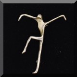 J069. Silver tone dancing figure pin. - $18 